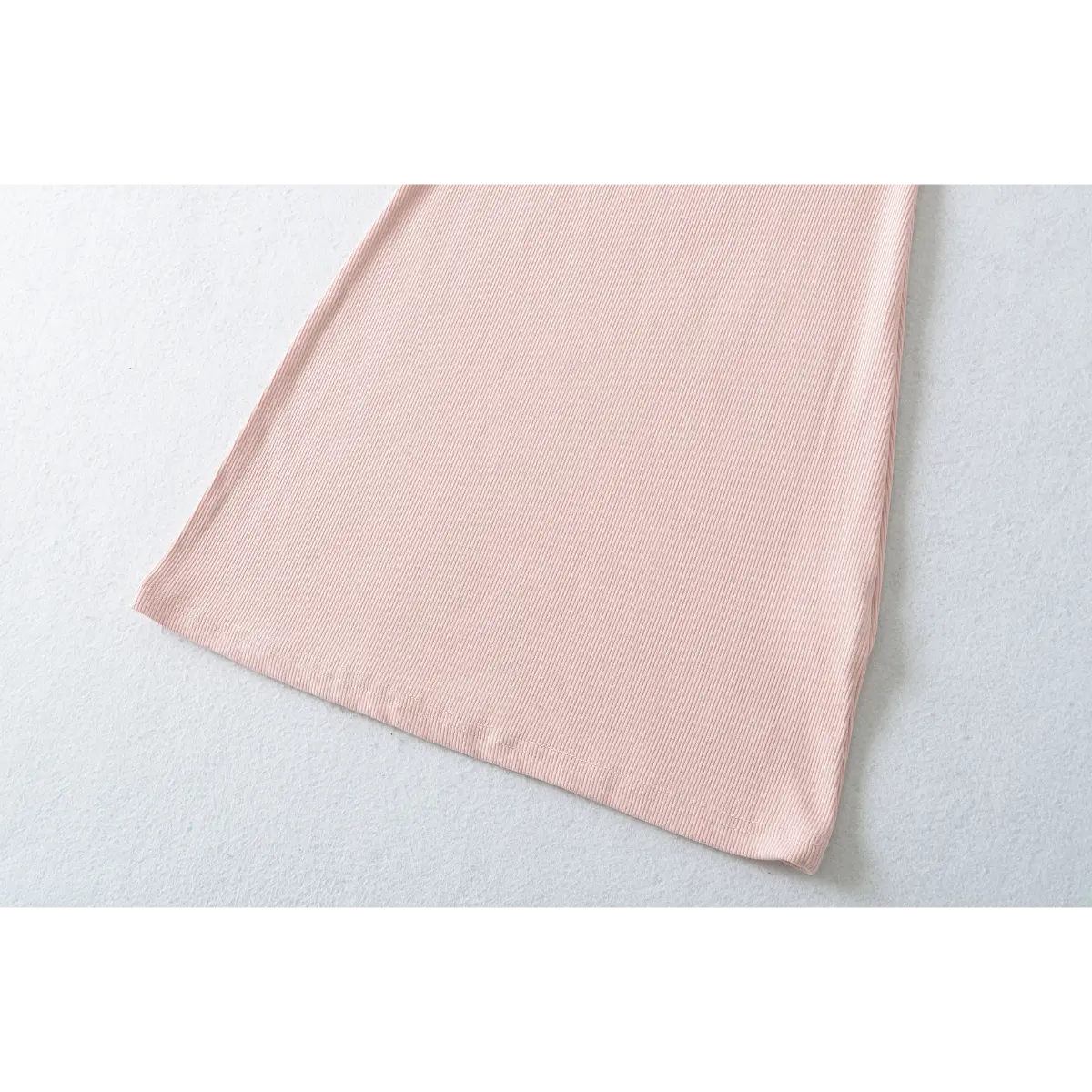 Back view of a pink ribbed off-shoulder dress, showing the fitted silhouette.