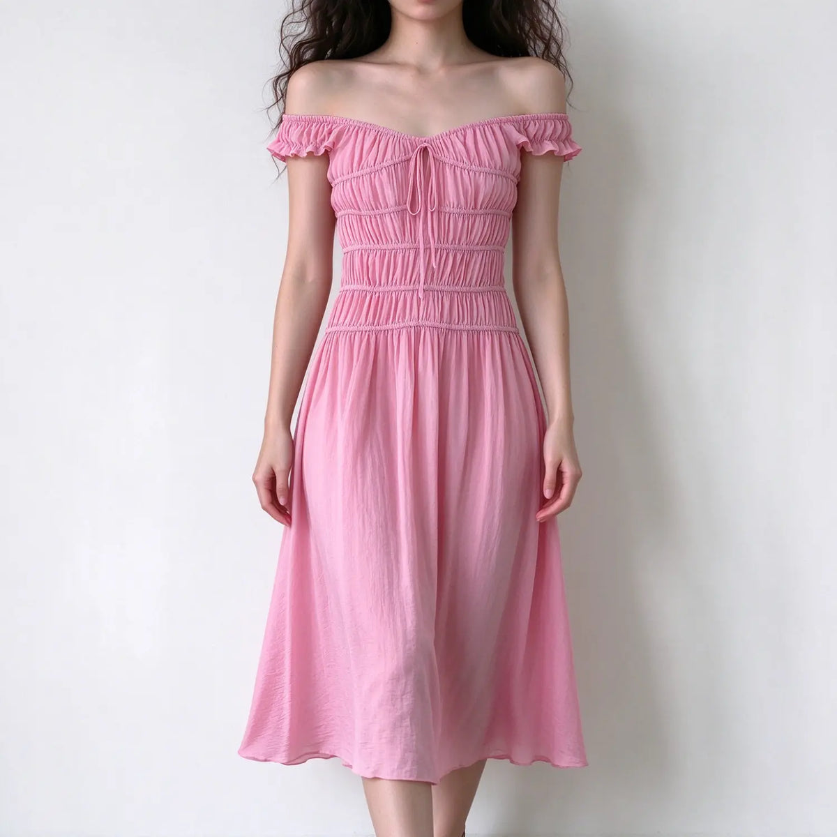 Model wearing pink off shoulder maxi dress, ruffle short sleeve, front tie detail, multi smocked tiered bodice, lightweight crinkle fabric, flowy A line maxi skirt