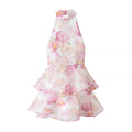 Full front flat view of a pink peony floral halter dress with a tiered ruffled skirt, high neckline, and sleeveless design.