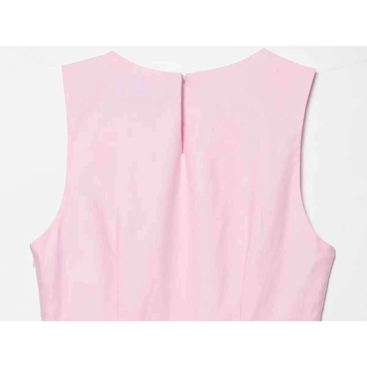 Back view of the top, showing the keyhole closure at the neck.