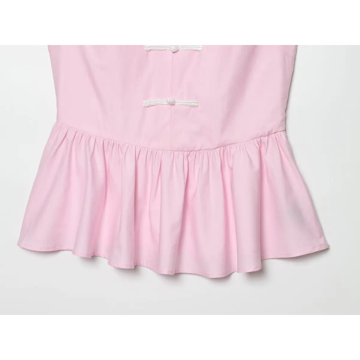 Close-up of the top's gathered peplum hem.