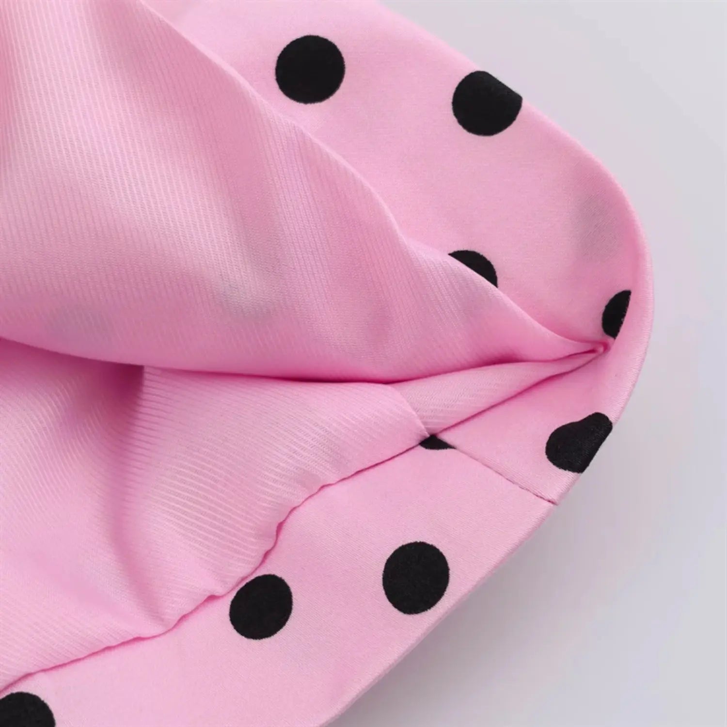 Inner lining partial shot, solid matte pink silky lining fabric, neat hem binding, contrast outer polka dot shell material