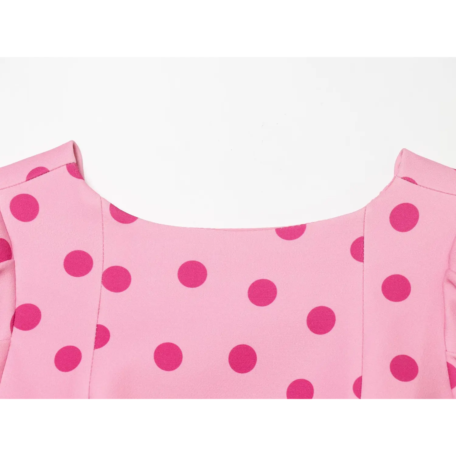 Closeup back scoop neckline, vertical shaping dart seams, two-tone pink polka dot print