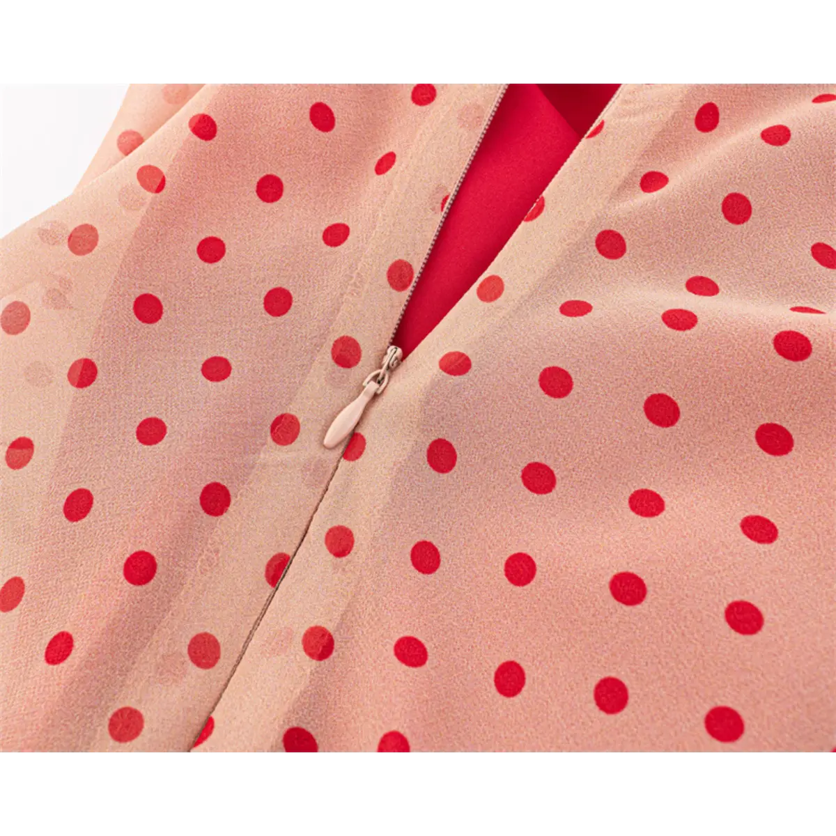  Close-up of the side zipper and polka dot print on the pink cami dress.