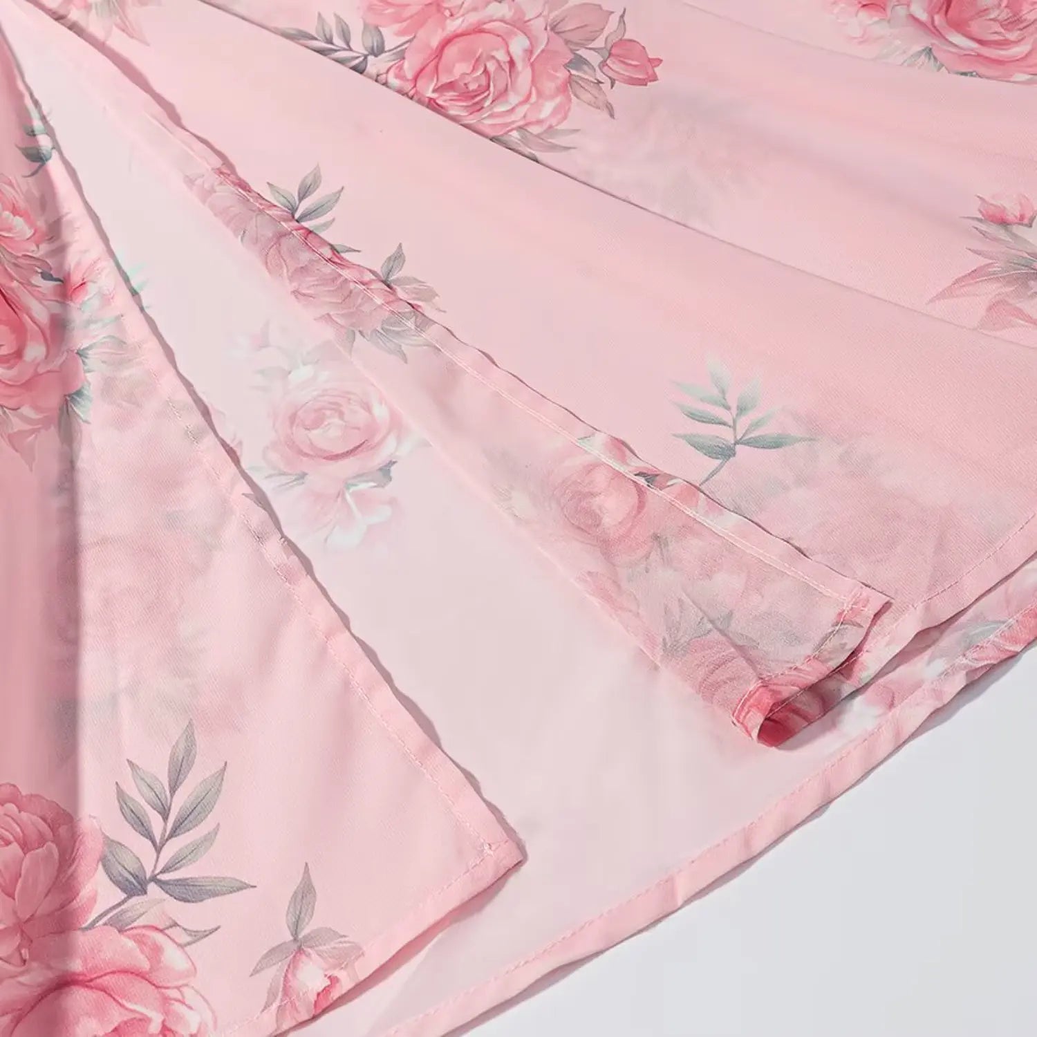 Mermaid skirt hem partial shot, double-layer flowy chiffon fabric, scattered pink rose print, neat finished edge stitching