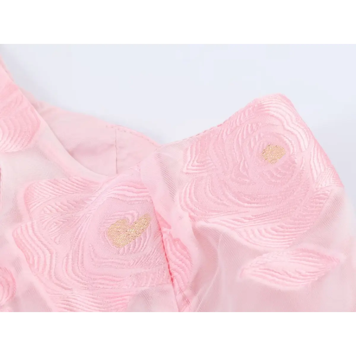 Close-up detail of the pink rose embroidery with gold center accents on organza fabric, showing the textured stitching and sheer overlay.