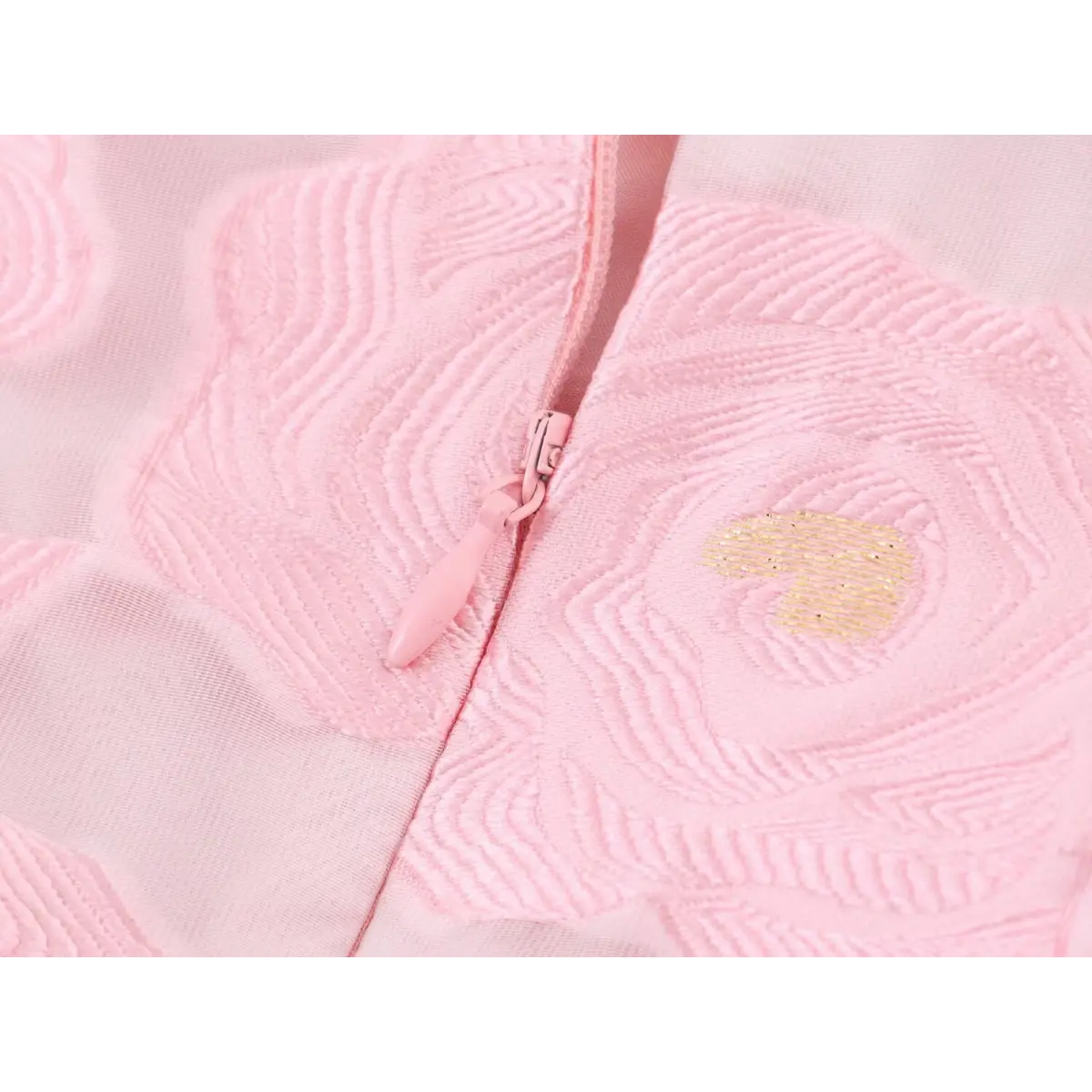 Close-up detail of the hidden center-back zipper on a pink rose-embroidered organza sundress, with a pink zipper pull matching the dress.