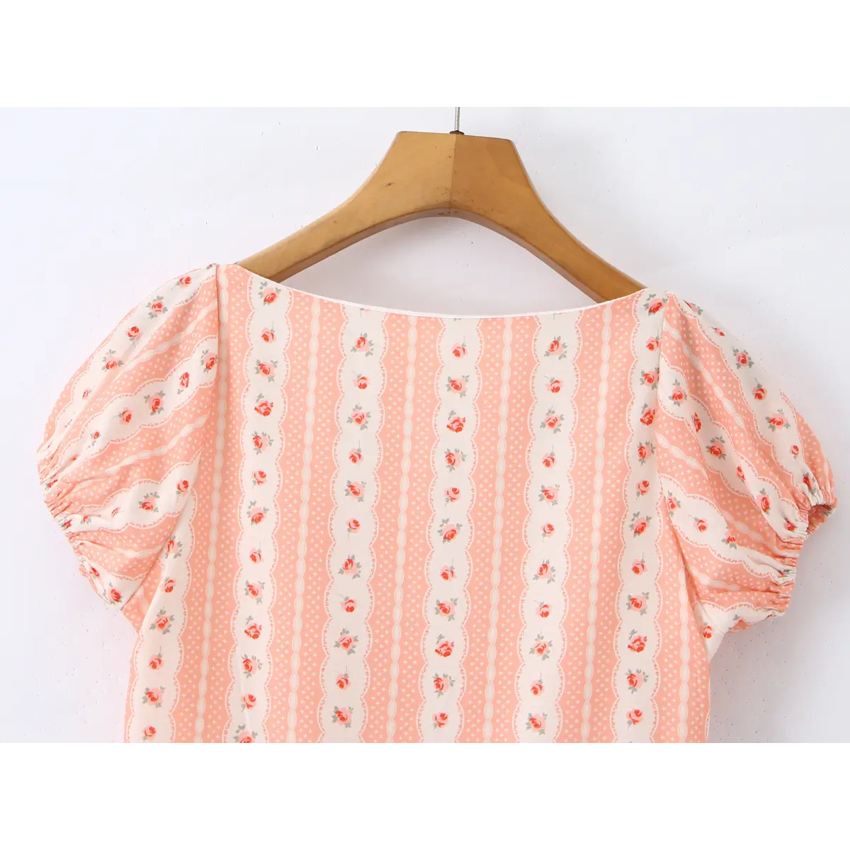 Close-up of the wide, boat-shaped back neckline and the gathered puff sleeve.