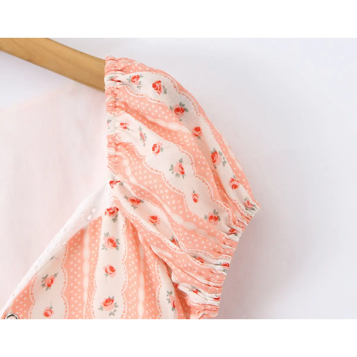 Close-up of the gathered puff sleeve, showing the elasticated edge and the rose print pattern.