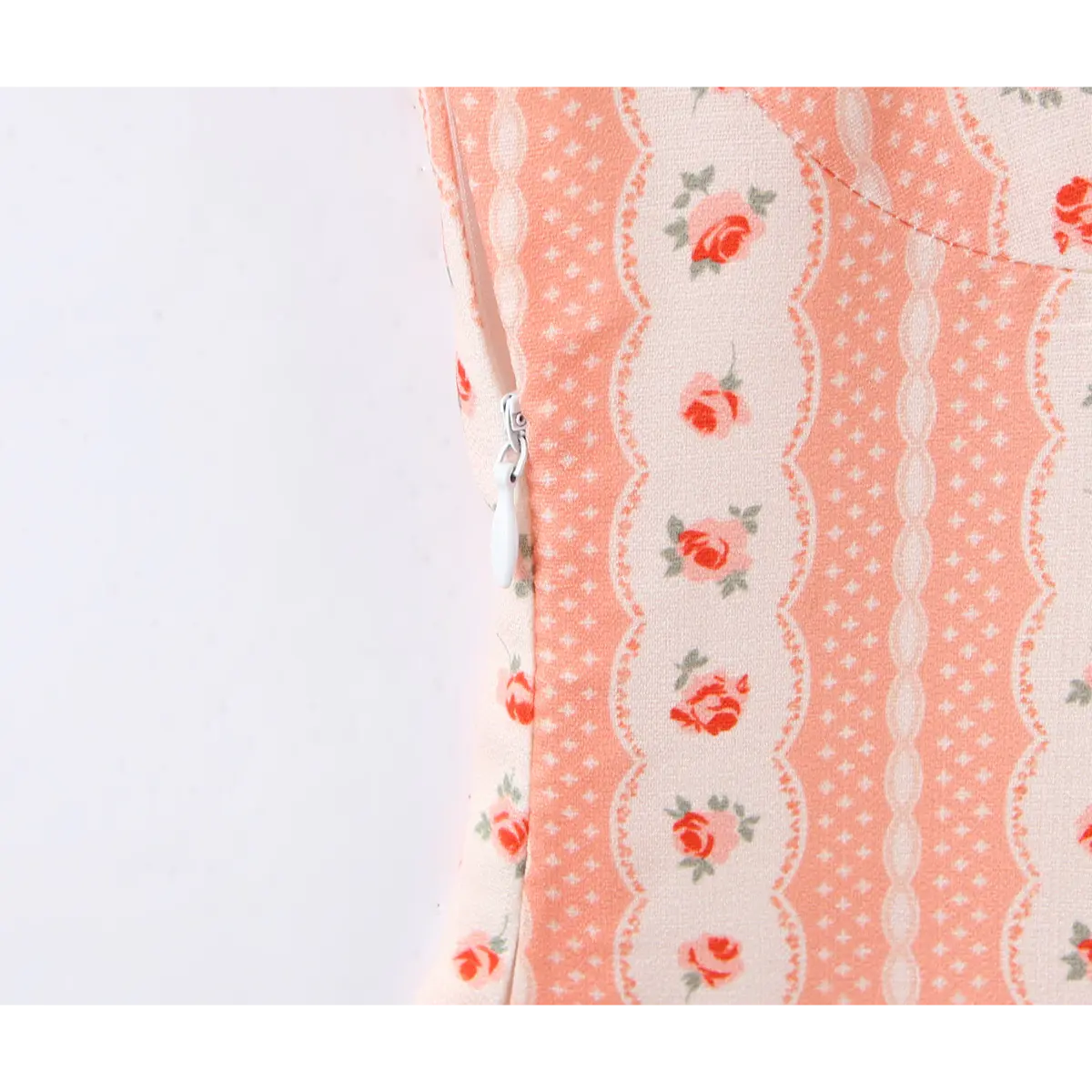 Close-up of the invisible side zipper, seamlessly integrated into the rose print fabric.