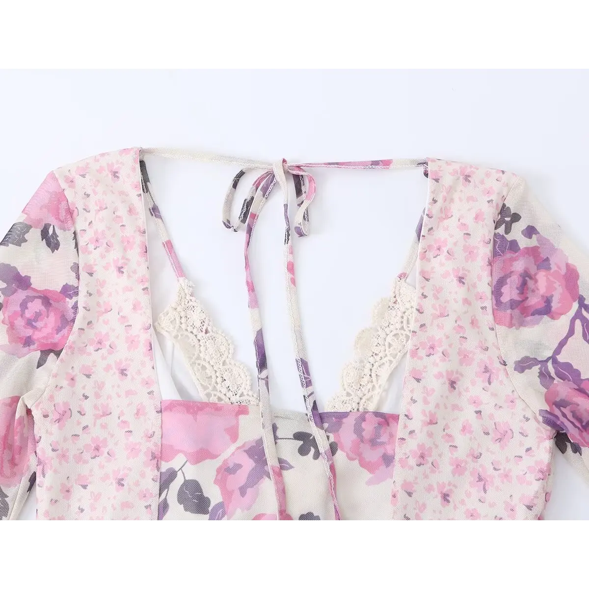 Close-up of the dress's back neckline, showing the open back, halter tie, and lace-trimmed inner lining.
