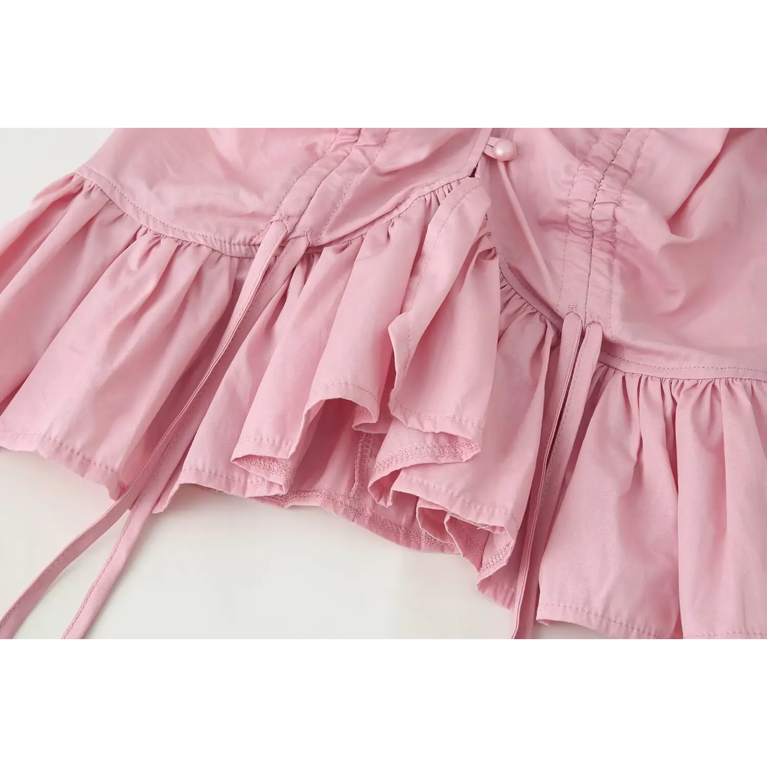Peplum ruffle hem and adjustable drawstring detail