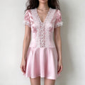 Model wearing pink satin lace trim puff sleeve mini dress, front view