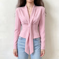 Model wearing pink shawl collar self tie fitted long sleeve blouse with jeans, front view