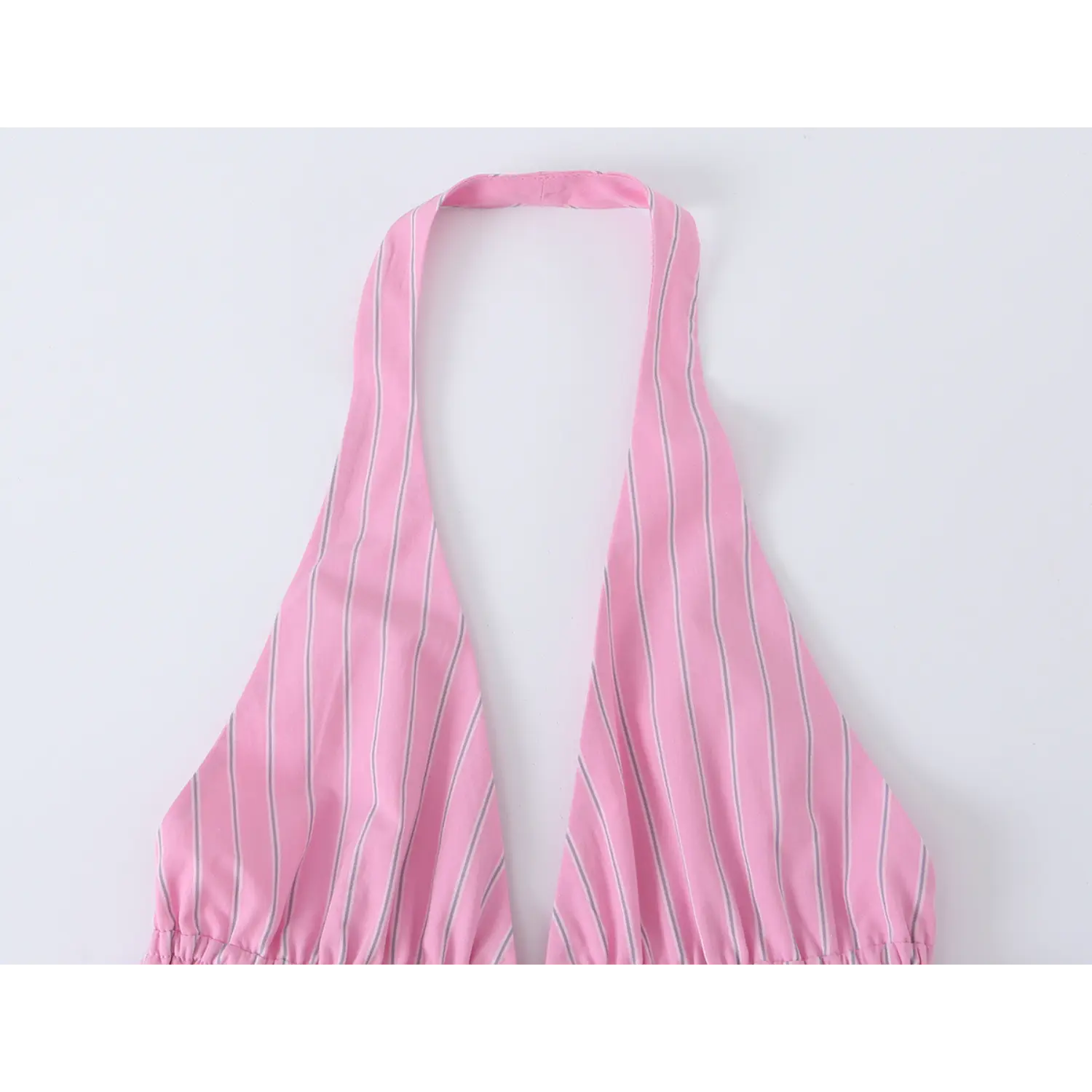 Partial close-up of halter strap and deep plunge v neckline on pink vertical stripe peplum cami