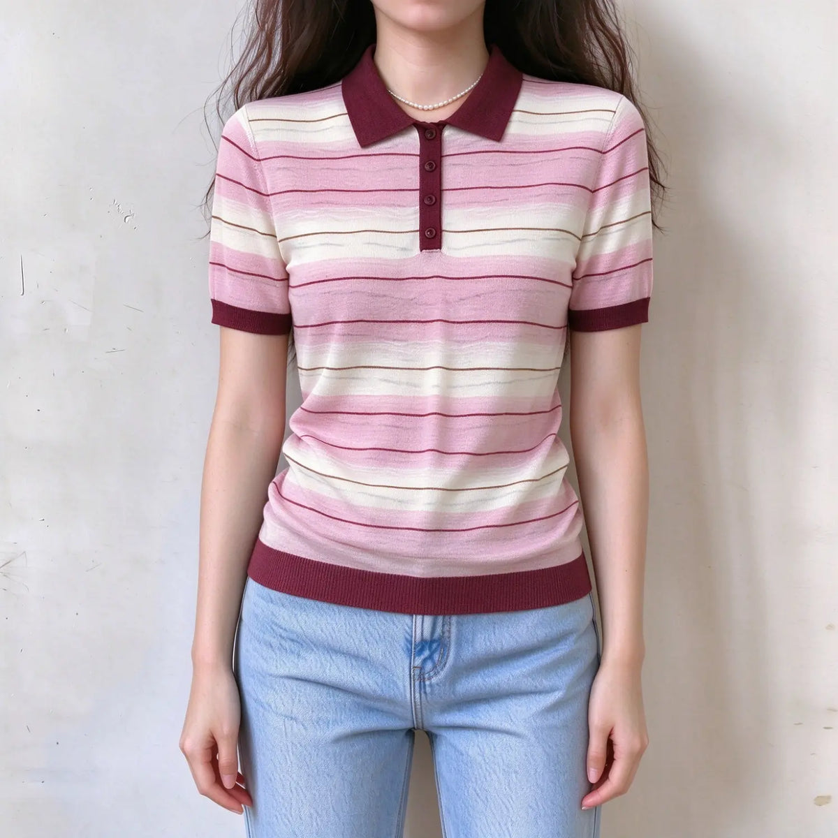 Model wearing pink gradient striped knit polo top, collared neckline, button placket, short sleeve, soft fine knit fabric
