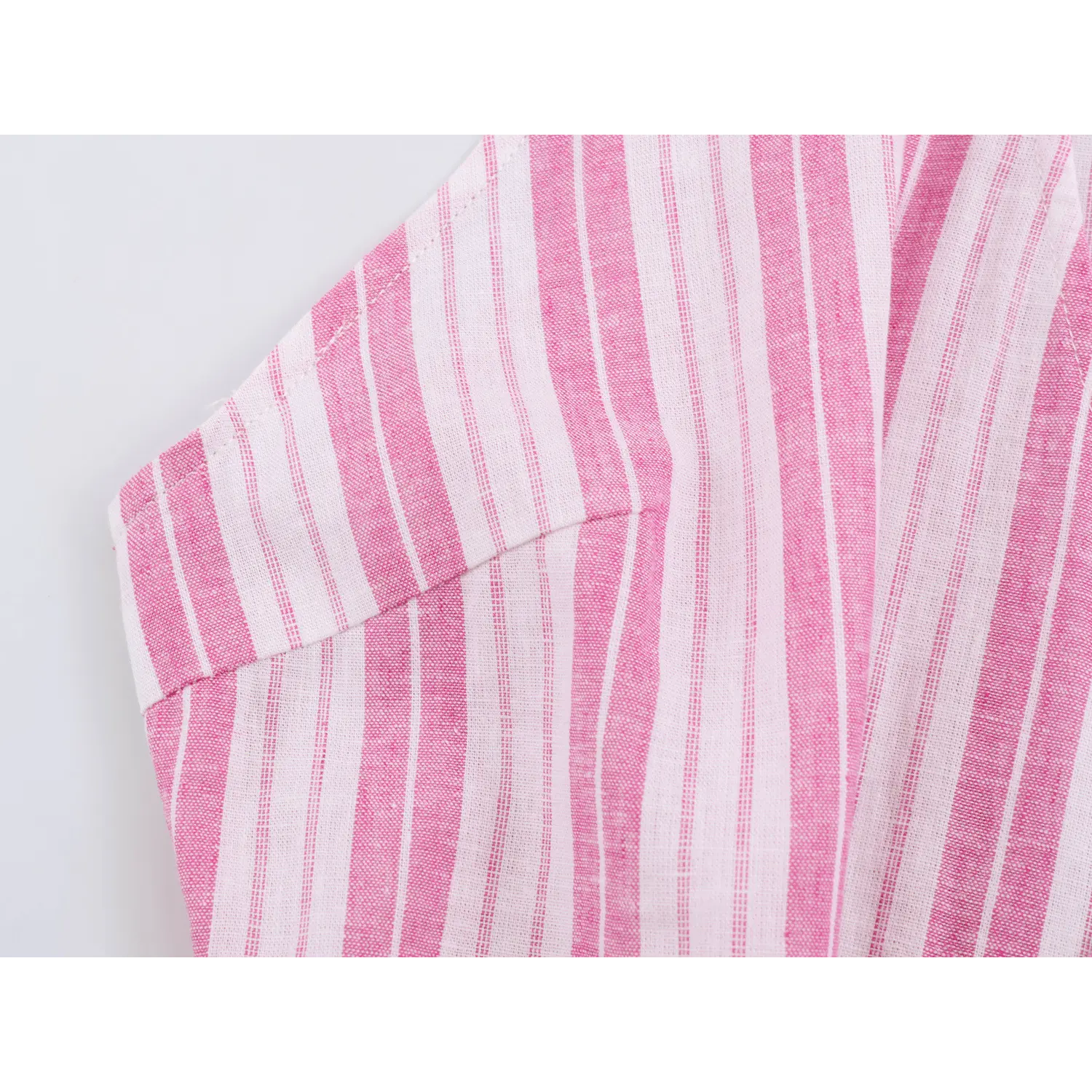 Partial shot of waist tailored darts, fitted shaping on vertical stripe halter cami top