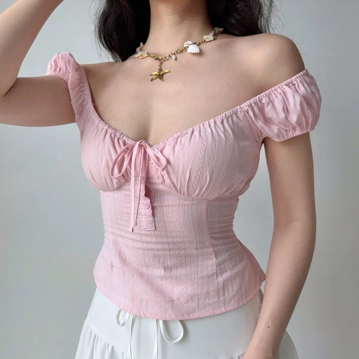 The top worn slightly off the shoulder, showcasing the puff sleeves and fitted silhouette.