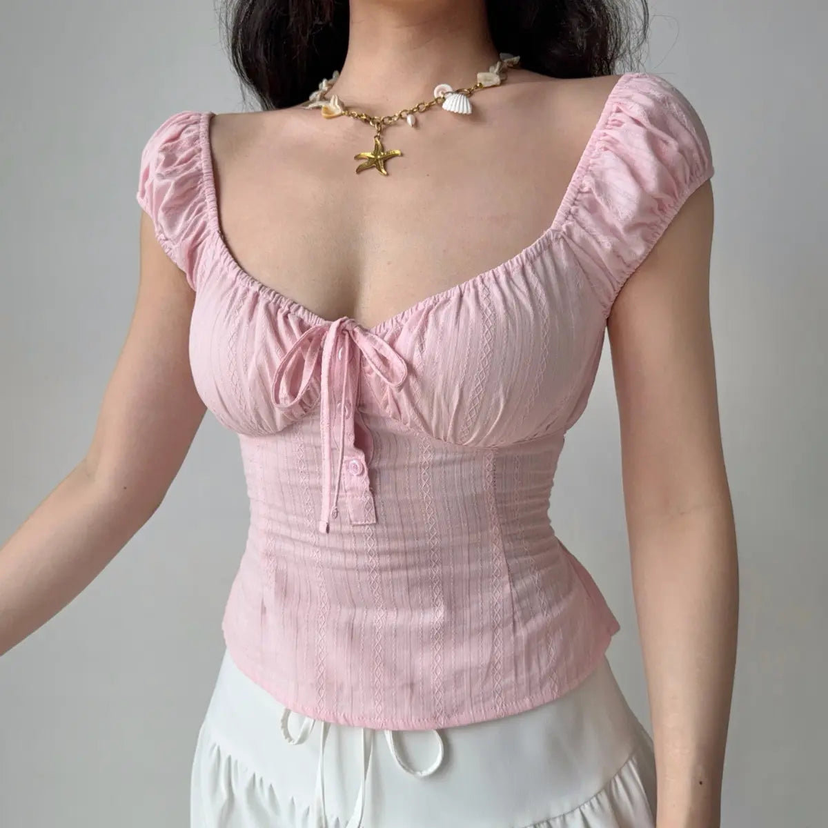 The complete outfit, featuring the pink top and white lace-trimmed mini skirt.