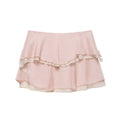 Back view of a light pink tiered chiffon mini skirt, highlighting the layered ruffle construction and soft, crinkled fabric texture.