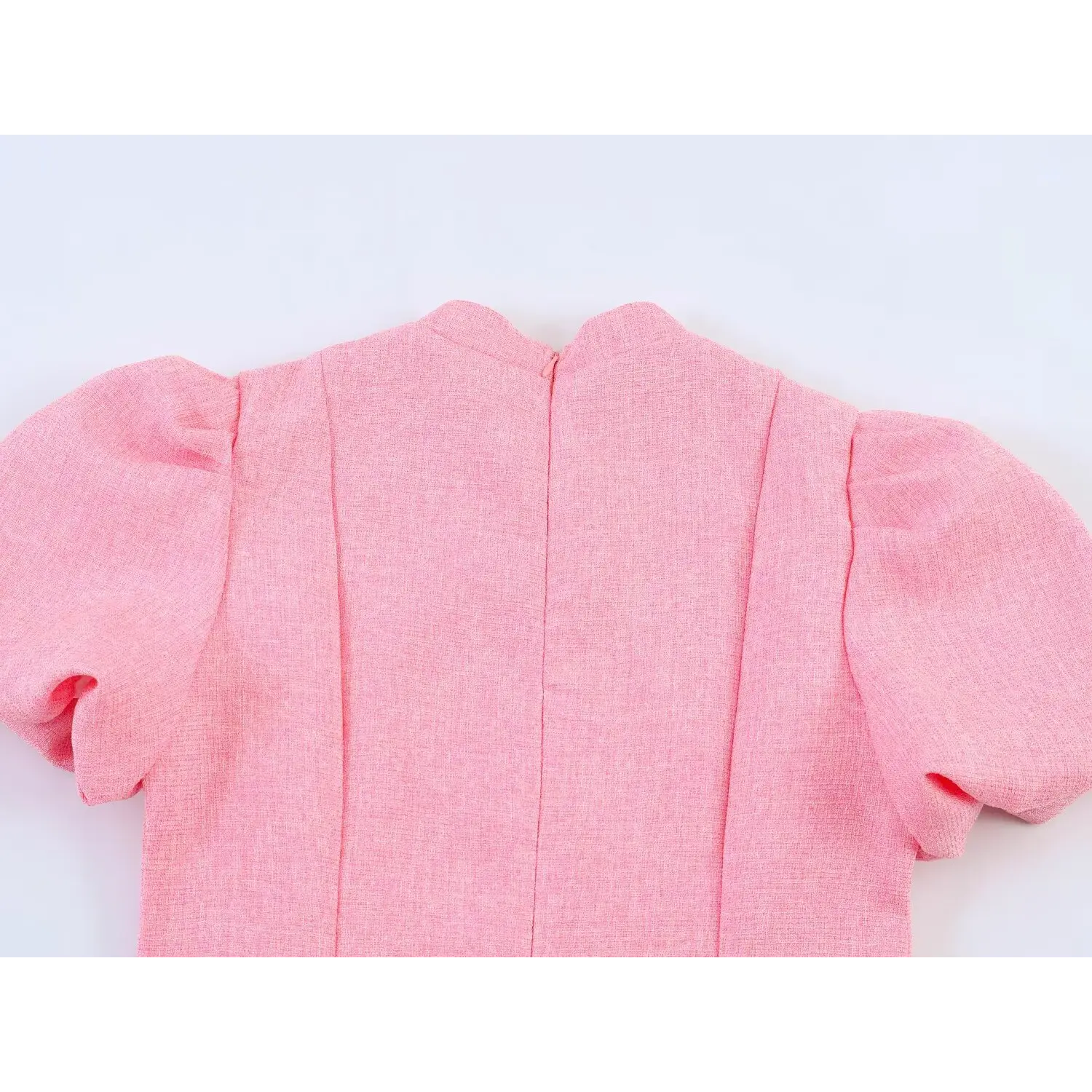 Back neckline shot showing vertical center seam, pink invisible back zipper and textured tweed shoulder panels