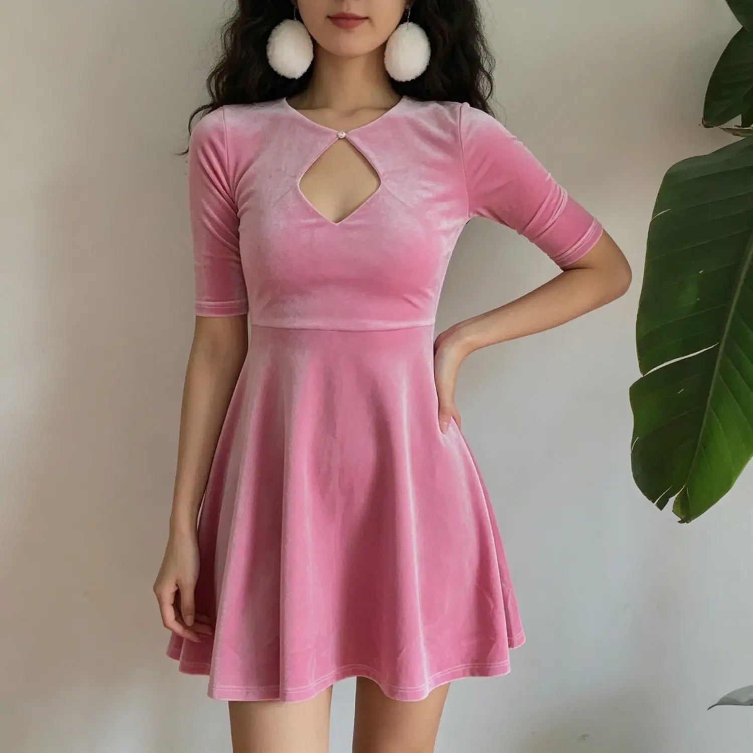 model-front-view | Front model shot pink velvet swing dress, neck diamond cutout with pearl button, short flared skirt