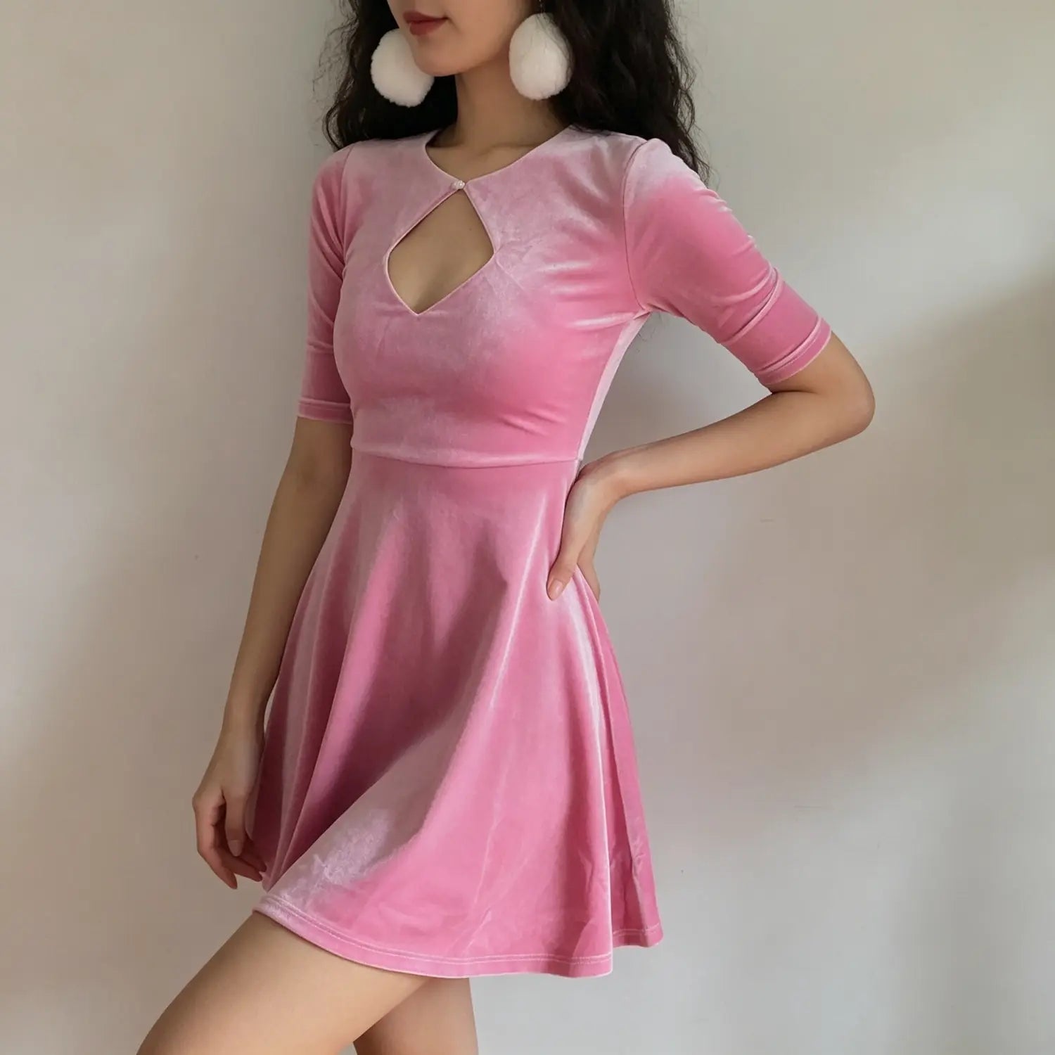 model-side-view | Side model wearing pink velvet fit and flare dress, front diamond hollow cutout, 3/4 sleeve design