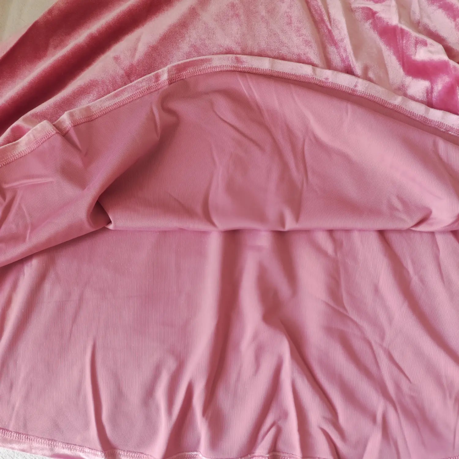 lining-detail-view | Inner lining close-up of pink velvet dress, flared skirt soft lining fabric and hem stitching