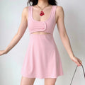 Model wearing pink sleeveless square neck waist cutout A-line mini dress, indoor lifestyle shot