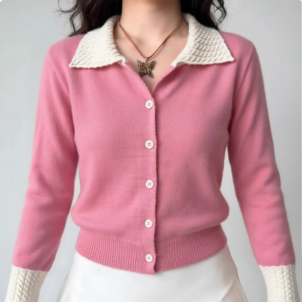 Female model wearing pink white colorblock knit cardigan, turn down cable collar, casual cropped sweater