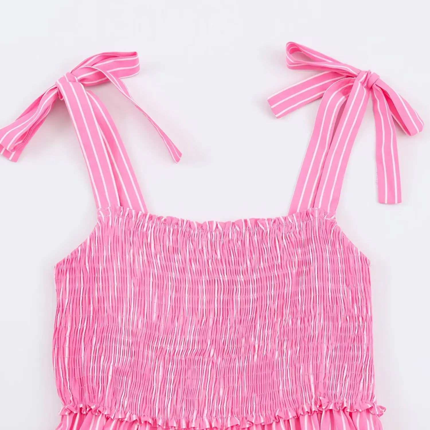 Flat closeup square neck smocked ruched bodice, self fabric tie shoulder straps, pink vertical stripe sundress
