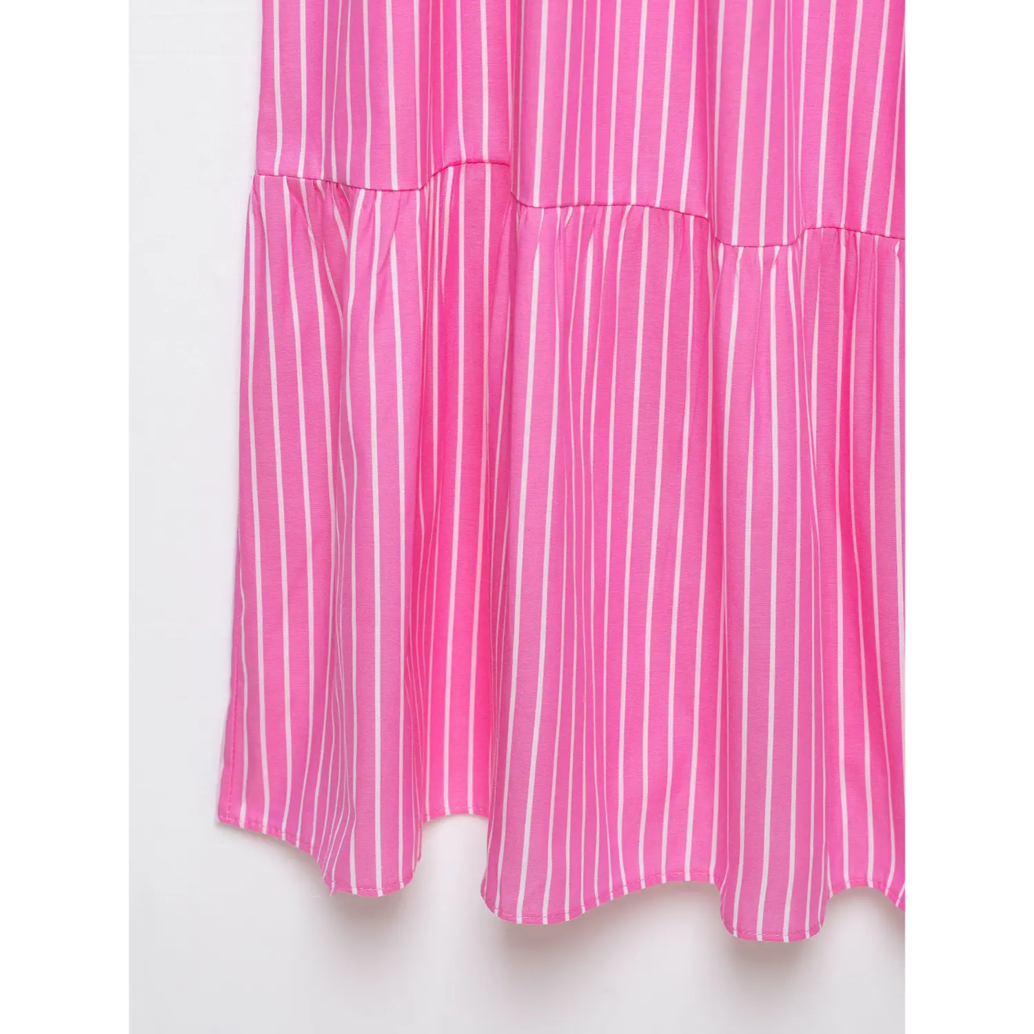 Mid skirt tier stitching closeup, horizontal gather seam separating main skirt and bottom ruffle tier, loose swing silhouette