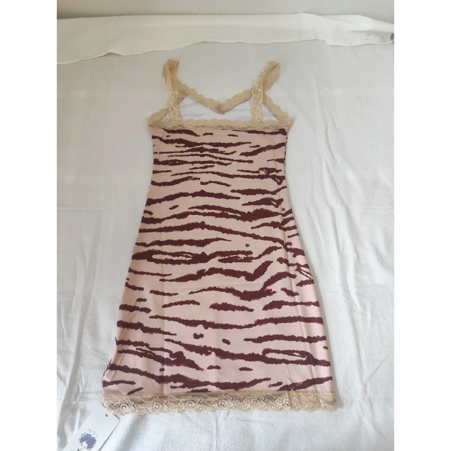 Flat lay back view, fitted pink zebra print lace trim cami mini dress