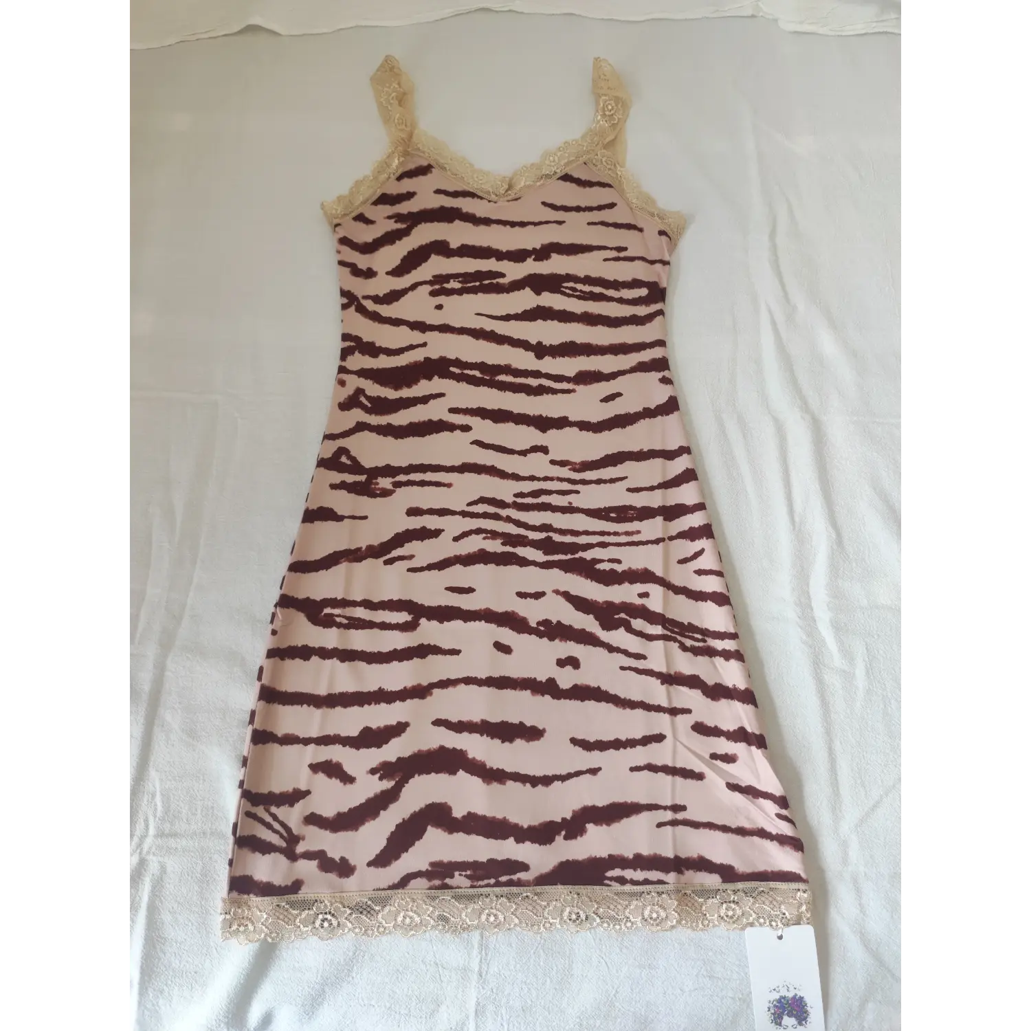Flat lay front view, pink zebra print cami mini dress with beige floral lace trim