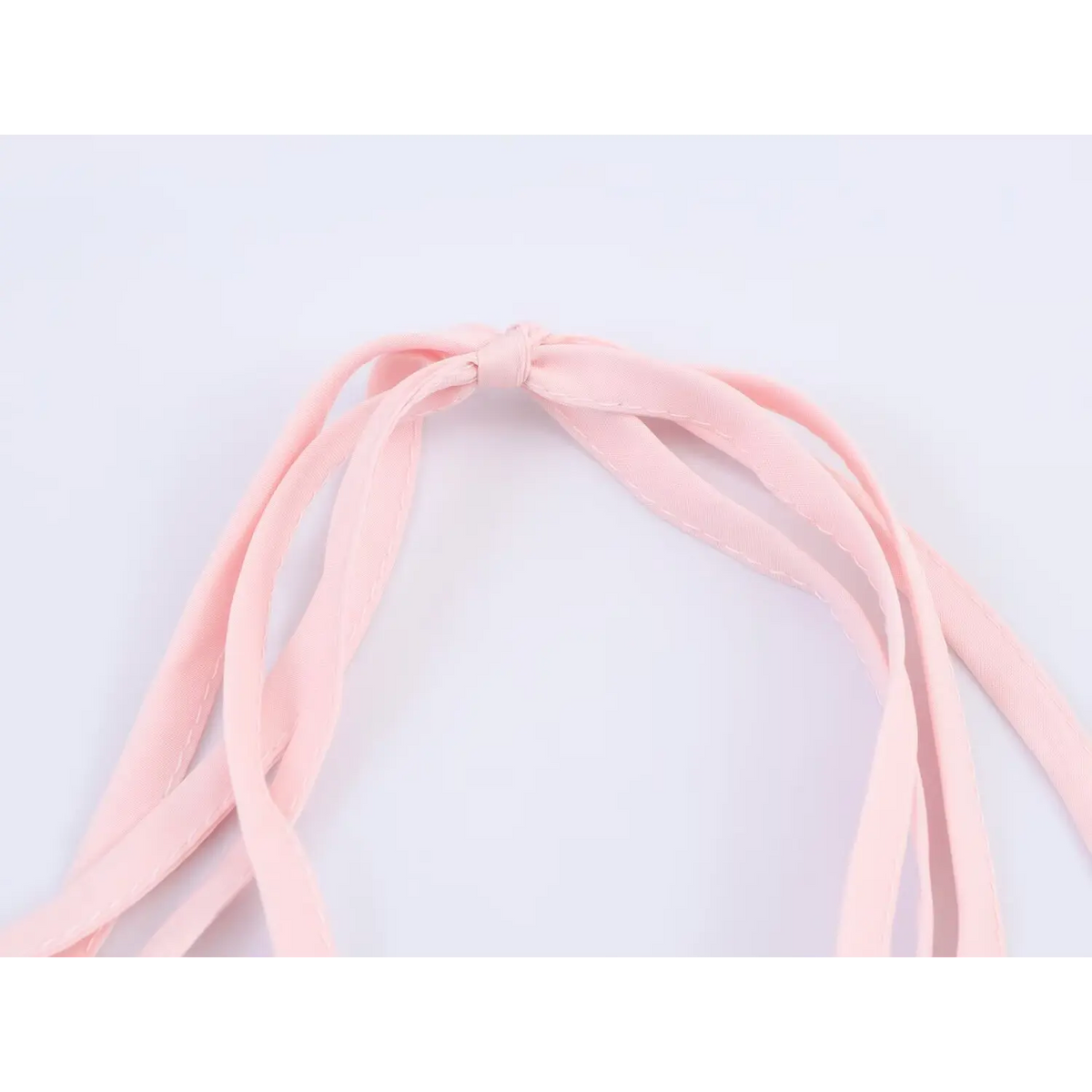 CloseClose‑up of pink halter neck tie strap