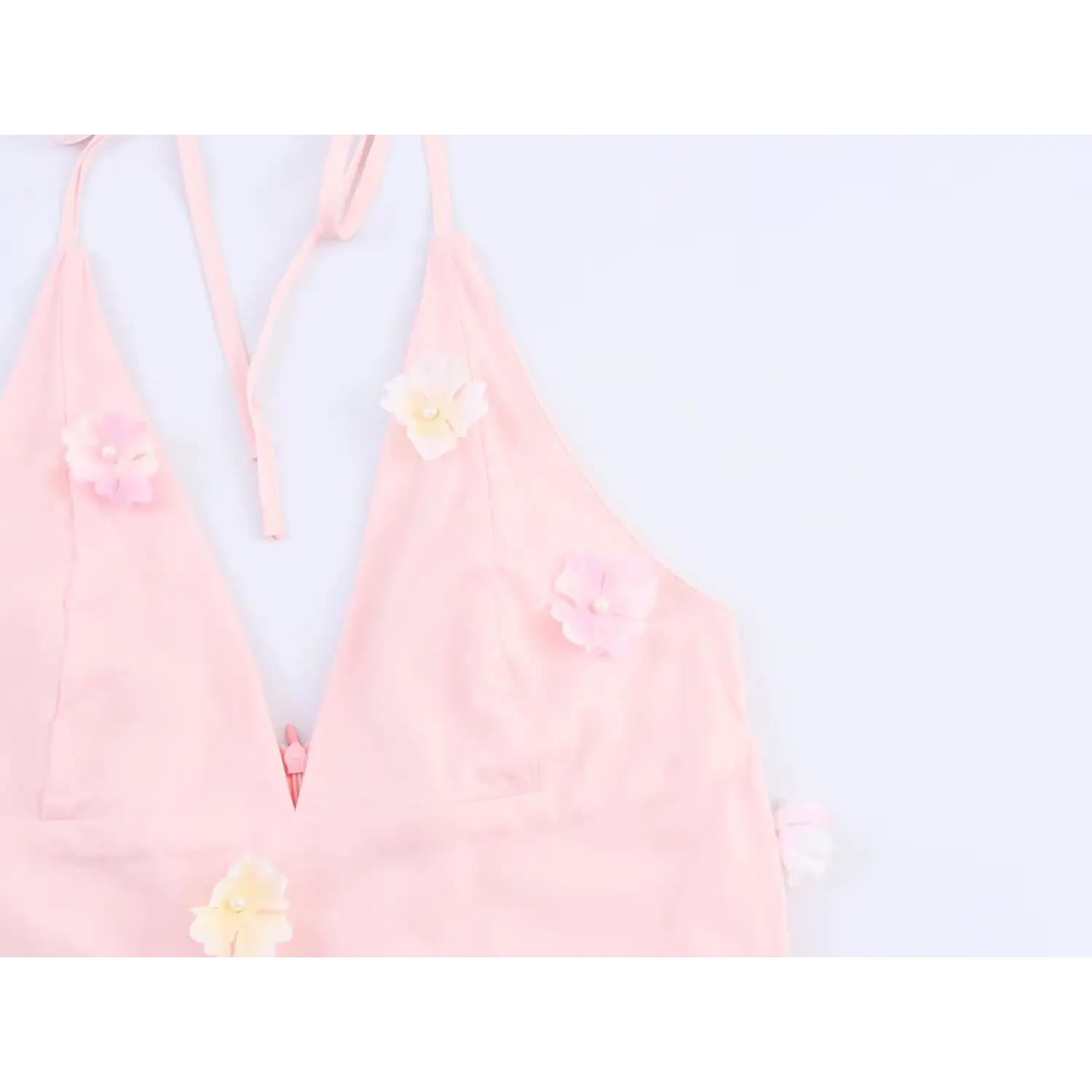 Close‑up of v‑neck bodice with 3d flower decor
