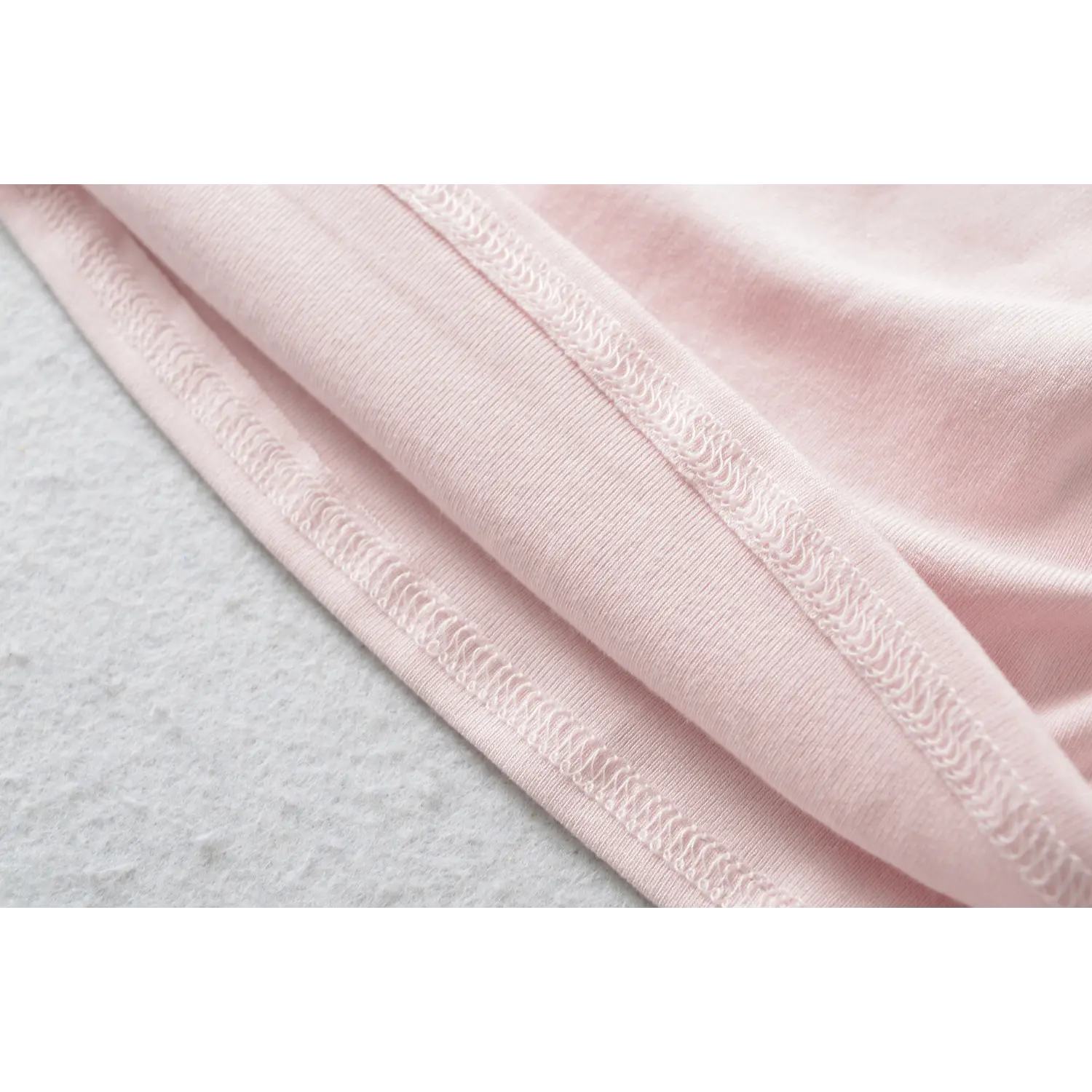 Fine elastic stretch stitching hem detail on light pink off the shoulder slim top