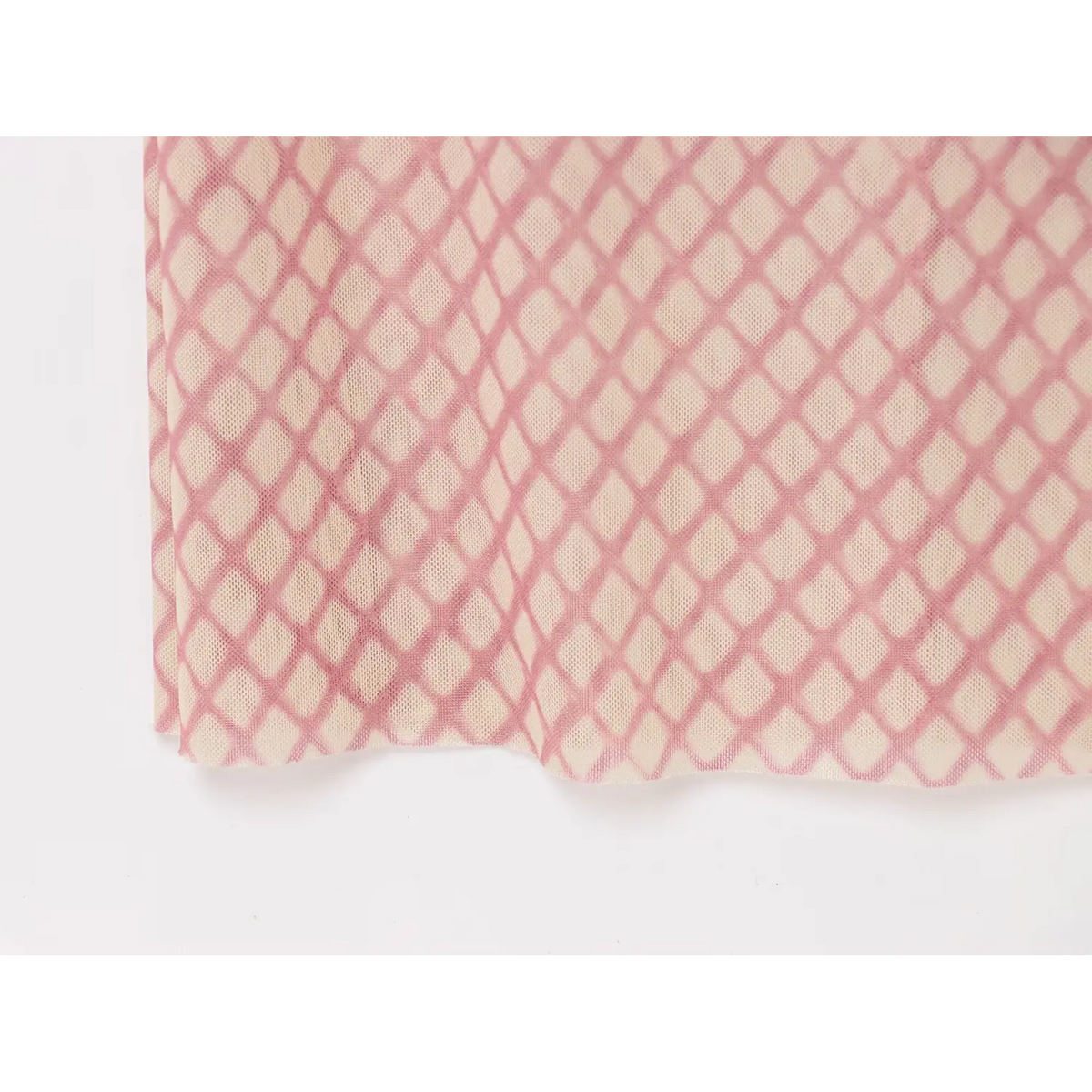 Close‑up of diamond mesh fabric and scalloped hem edge