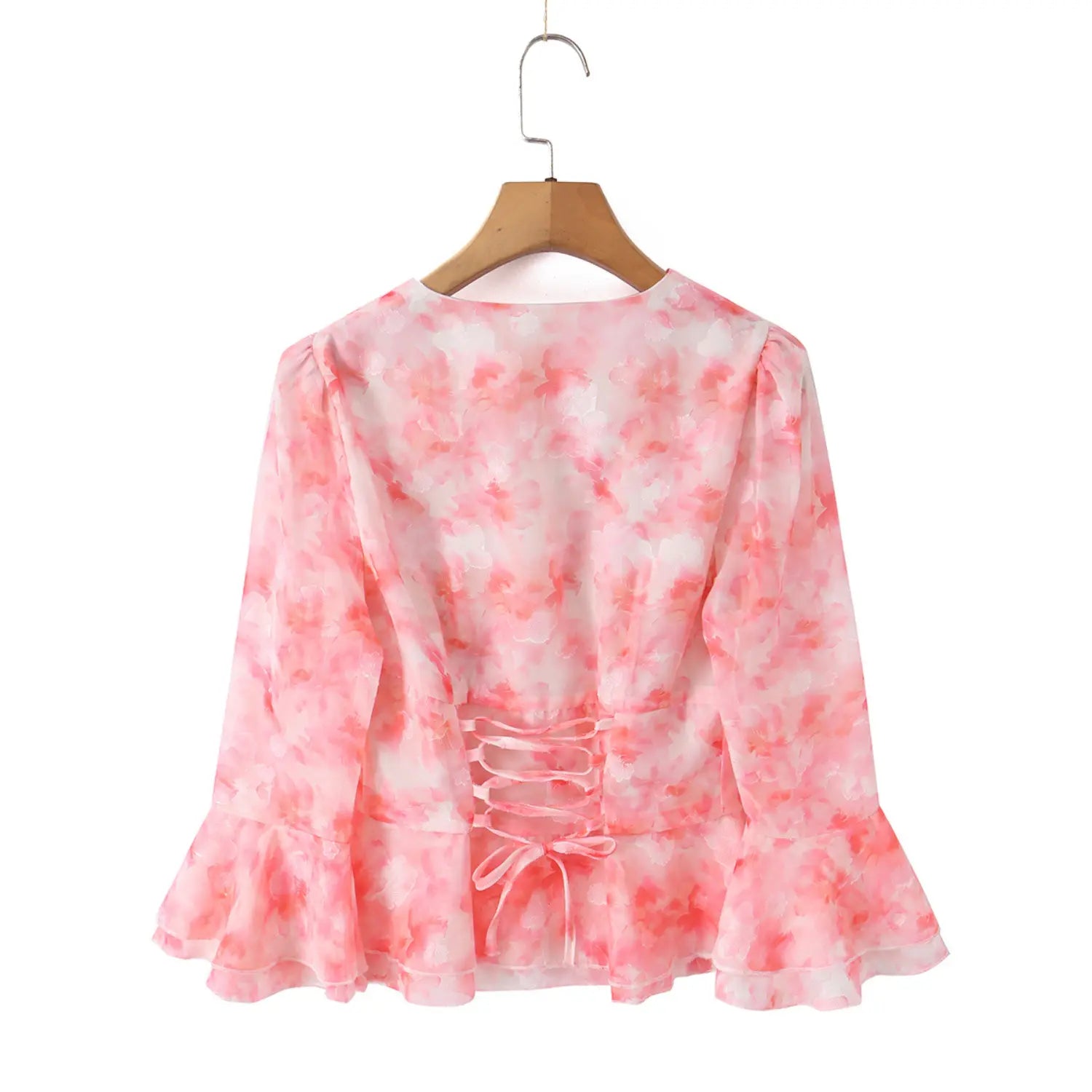 Back view pink floral chiffon blouse on hanger, corset lace‑up tie back detail, long bell sleeves, cropped peplum silhouette