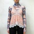 Model wearing pink ditsy floral lace cami vest layered over blue angel cloud print mesh turtleneck