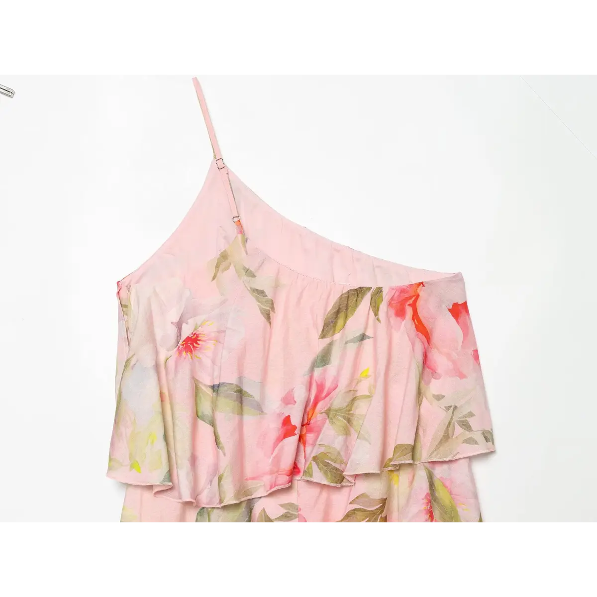 Close‑up of ruffled bust tier on pink floral one‑shoulder maxi dress