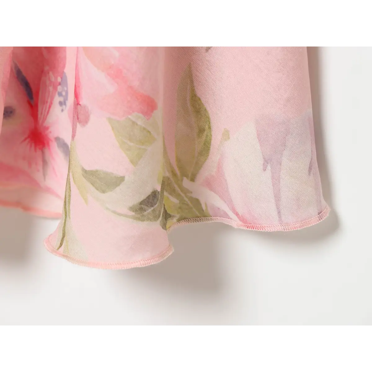 Close‑up of multi‑layer tiered ruffle hem with pink floral print