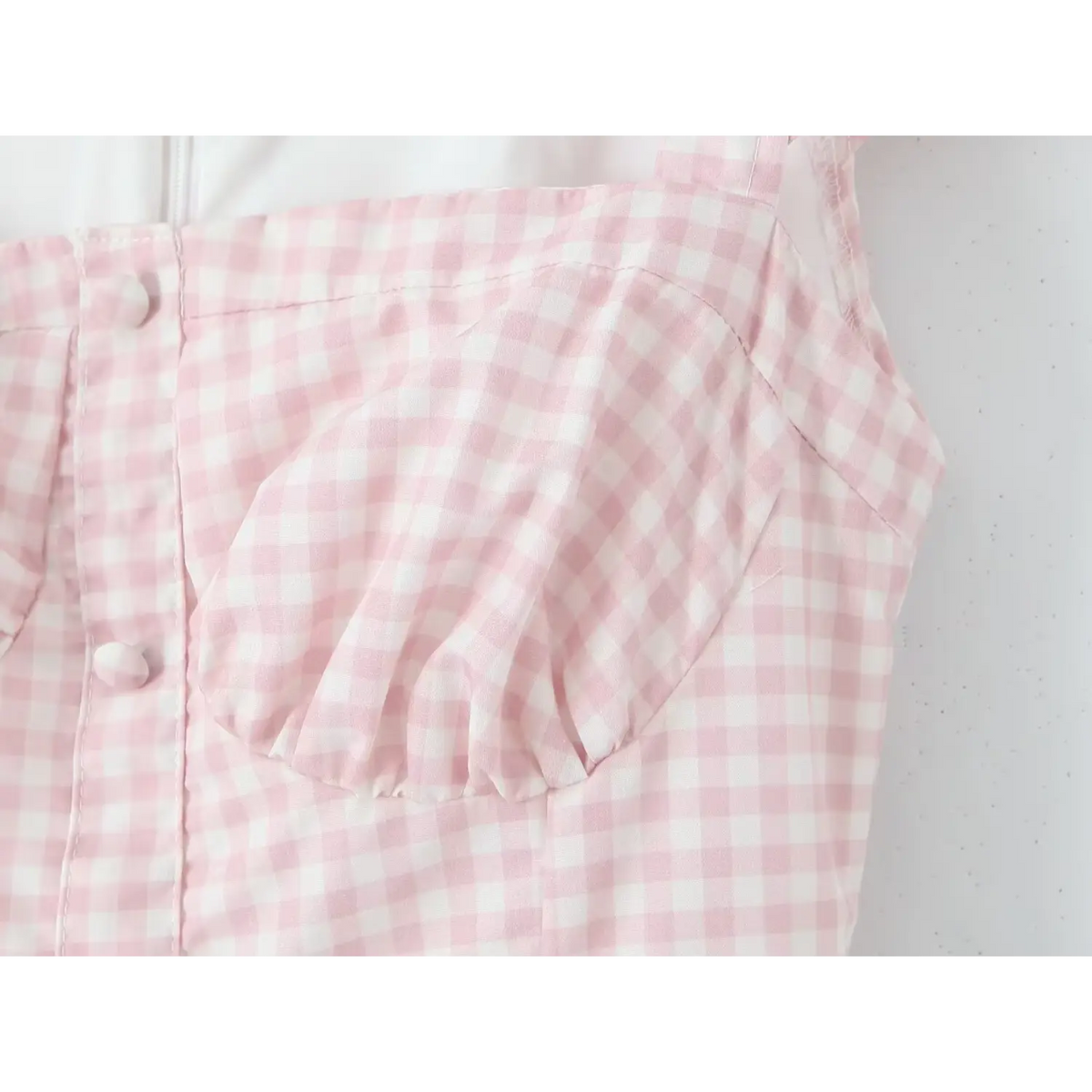Close‑up of front button placket and gingham bust construction