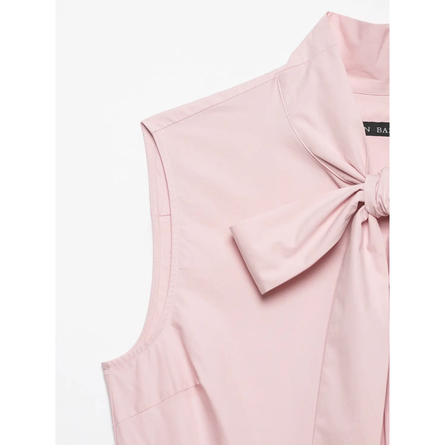 Close‑up of stand collar with front fabric bow detail