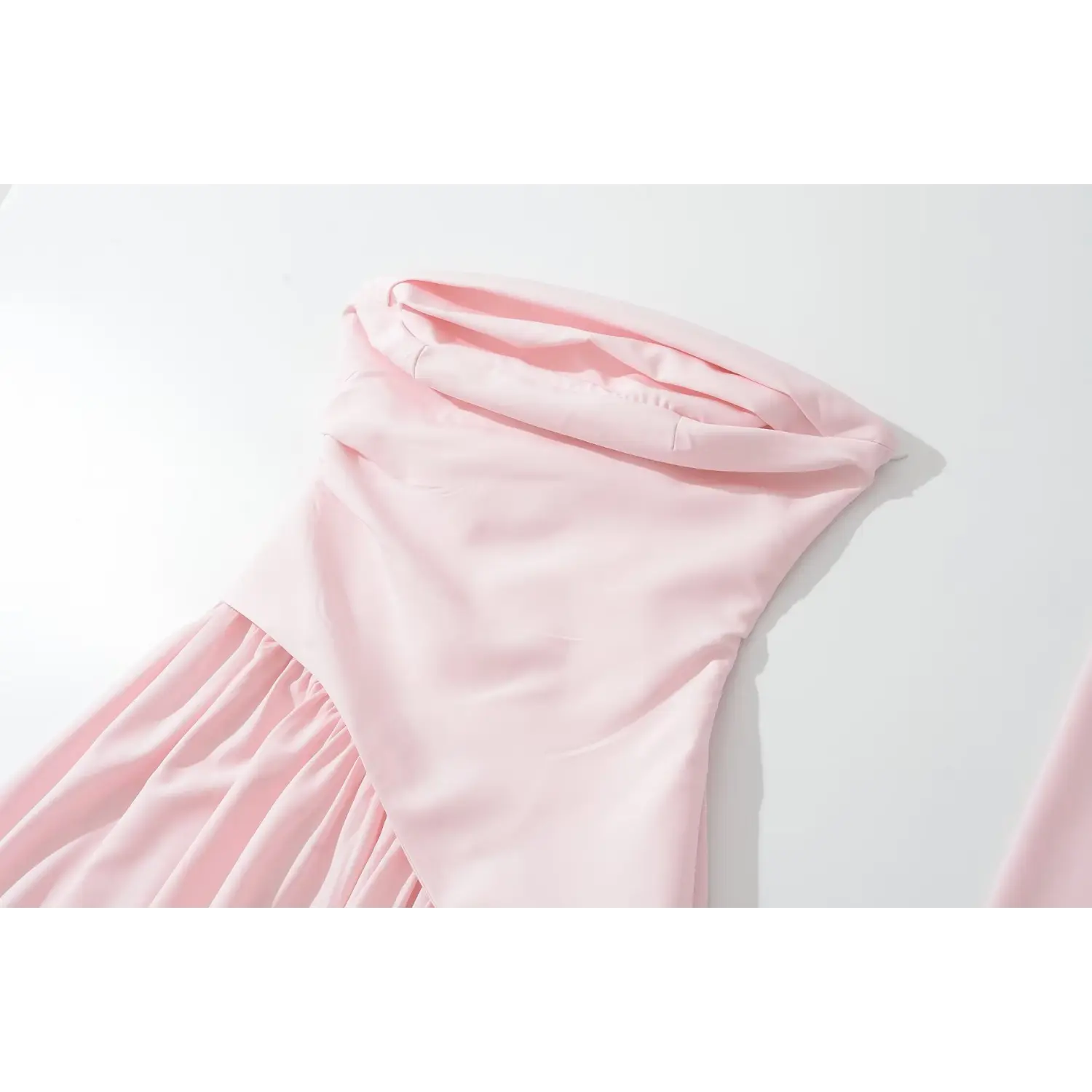 Partial close‑up of pink folded halter neck and bodice seam
