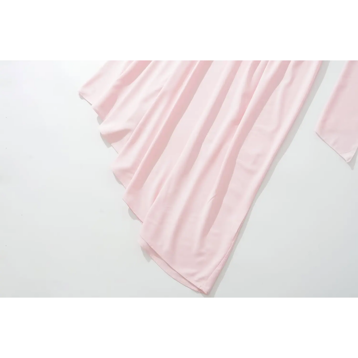 Close‑up of soft pink pleated skirt fabric drape