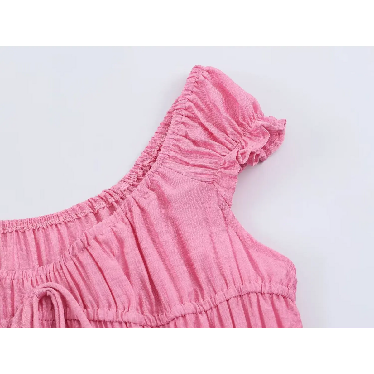 Close‑up of ruffle cap sleeve and shoulder stitching detail