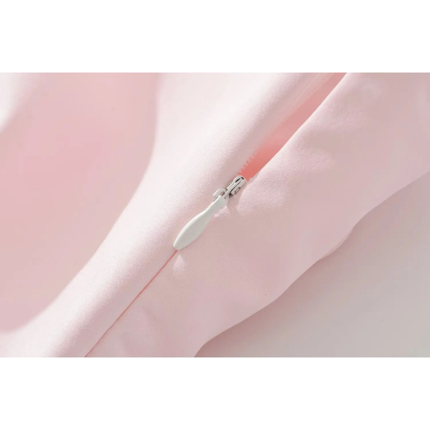 Macro close‑up of concealed side zipper on pink bodice