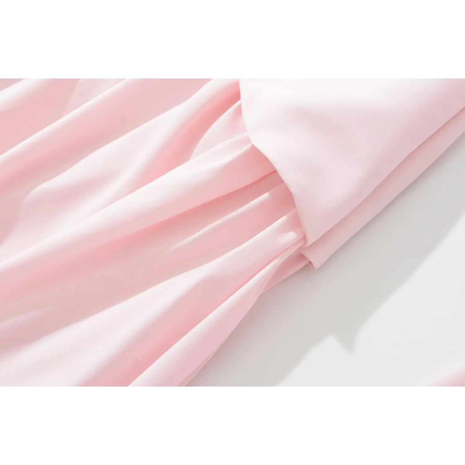 Close‑up of pleated skirt folds and fabric seam