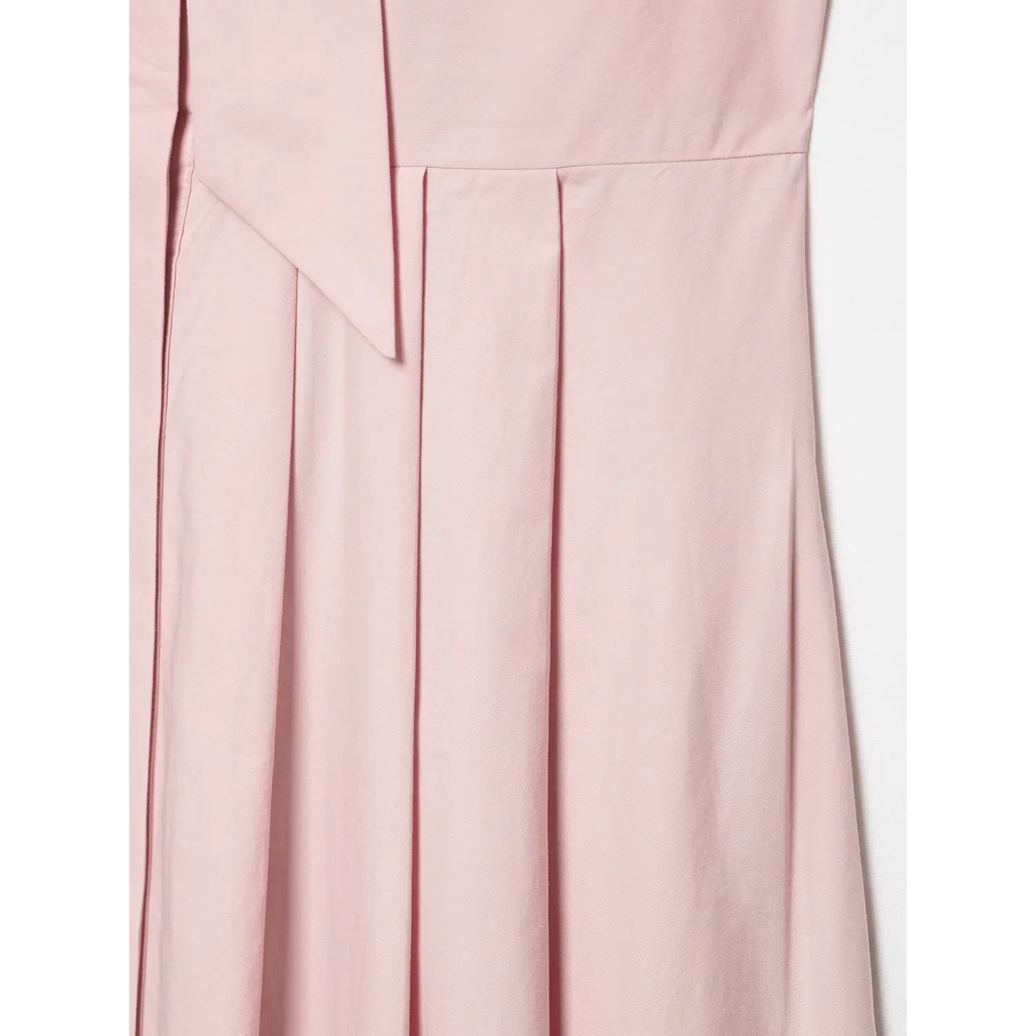 Detailed close‑up of vertical pleats on skirt panel
